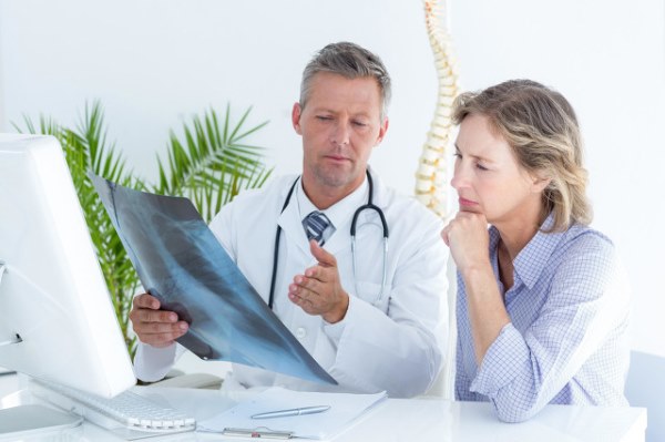 Doctor showing xray to his patient in medical office.jpg