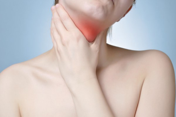 Young woman holding her painful neck.jpg